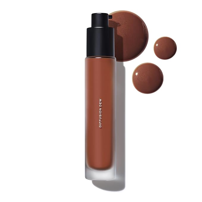 MAKE Beauty Diffusion Dew Skin Tint. Sheer to Medium Coverage Radiant Finish. Blurring, Smoothing, and Brightening for Glowing Complexion. Enhanced with Niacinamide and Adenosine. Rich Cocoa 18